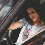 woman driving on car