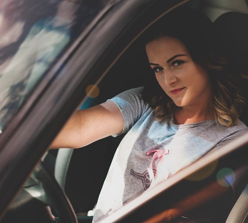woman driving on car